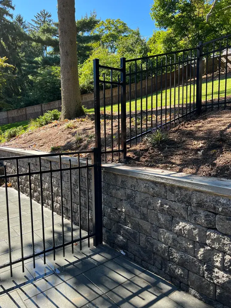 Aluminum Fence on a Stone Retaining Wall